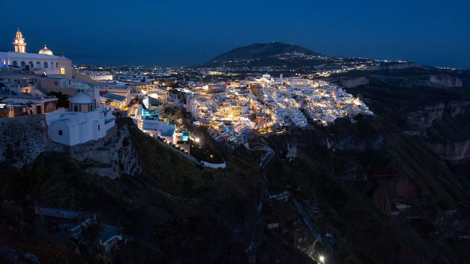 Fira lit up at night on the edge of the caldera
