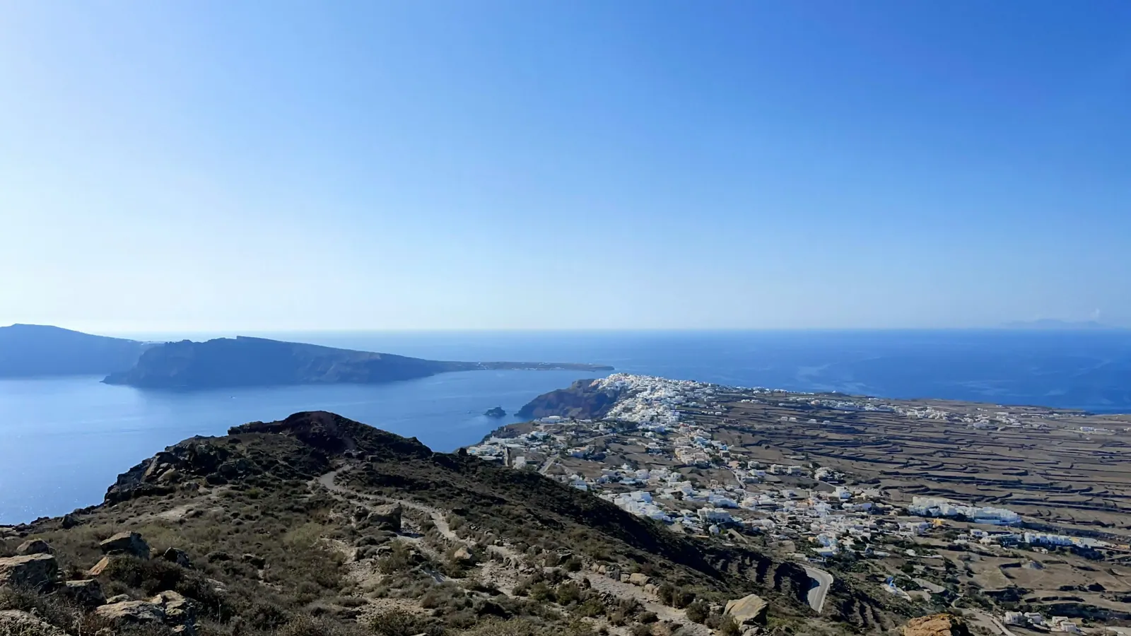 Imerovigli and Skaros rock from above, with the road along the caldera rim
